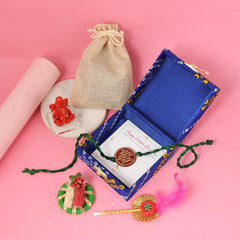 Rakhi a blue box and a small bag on a pink background